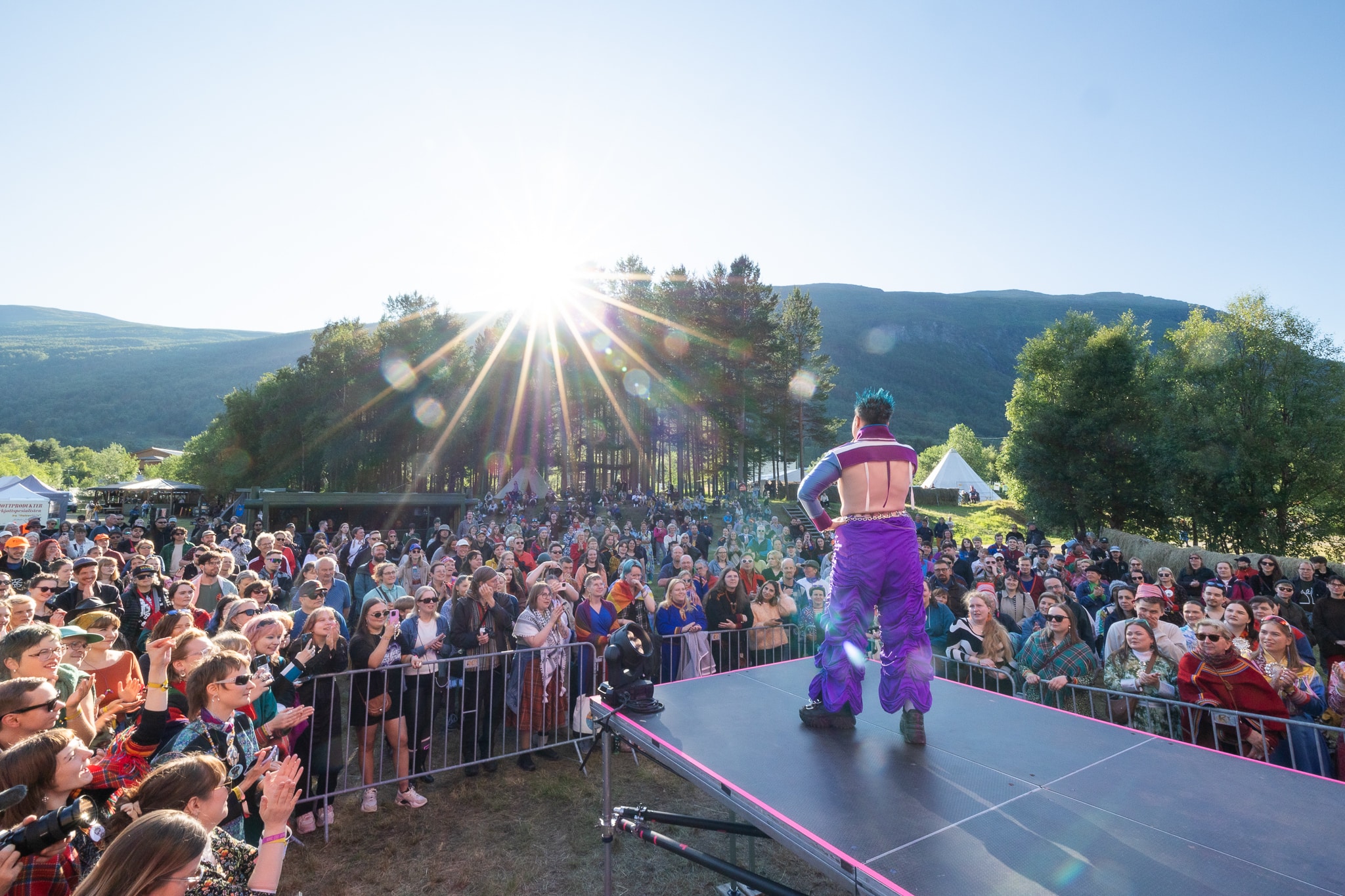 A drag artist performing on stage in front of an audience.