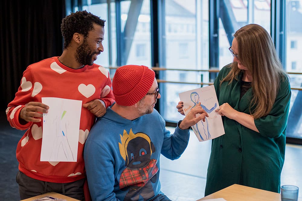 A photo of three people looking at a