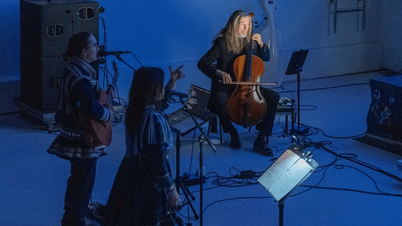 Musicians playing in blue lighting